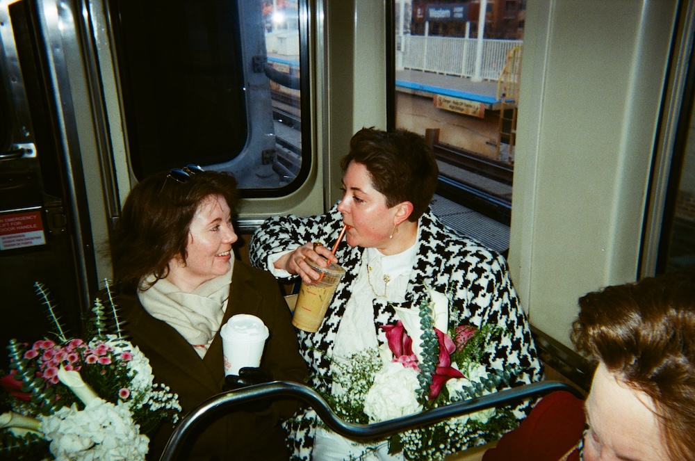 Kelly and Mara on the Chicago L with bouquets